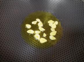 锅里继续倒油烧热，下入蒜片炒香。