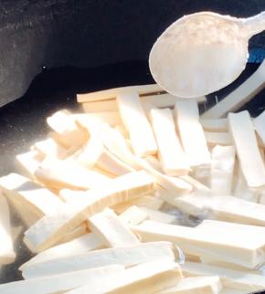 白豆腐干洗净切条，冷水下锅，加少许盐煮沸后捞出备用
