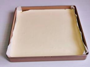 烤盘垫上油纸，倒入蛋糕糊，震出气泡。