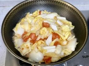再下入白菜，加半碗清水翻炒片刻。