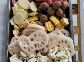 先把所需的食材处理好：
玉米洗净切成小块，藕和土豆削皮洗净切成厚一点的块，花菜洗净切成小朵，小火腿肠和肉丸清洗干净捞出沥干水分备用！