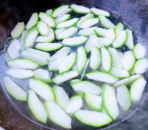 锅中烧开水放入少许盐和一点点油再放入西葫芦片焯水至断生即可时间不宜过长