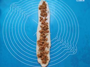 再次擀开，挤上沙拉酱用勺子抹匀，撒上海苔肉松。 