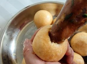 用裱花袋把肉馅儿挤入油面筋中，再用大拇指轻轻把肉馅儿按压一下！