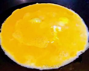 锅中倒入底油加热再淋入打散的蛋液