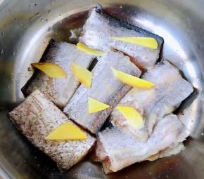 姜片依次摆在带鱼上煨制十分钟左右