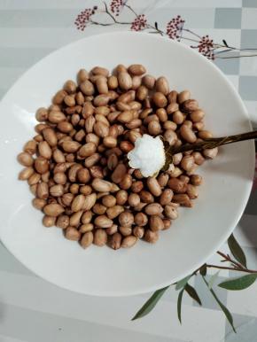 放入盘子里，加入一勺盐拌匀！让花生自然冷却！