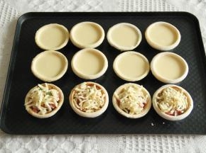 步骤9、把冷冻中的其余6只挞皮取出，8只倒入挞液。其余4只，刷上一层黑椒酱，放上培根、甜玉米、豌豆，撒上芝士碎。