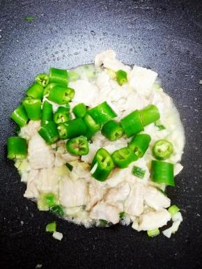 把青椒段放入锅中，翻炒均匀