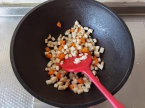 翻炒至微微变软，就可以倒入之前炒好的鸡胸肉丁，一起翻炒了一会。然后淋入小半碗清水，搅匀。