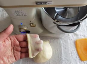 4、转1档打至黄油与面团融合，转4-5档打至面团光滑挂钩。取出面团折叠收圆，检查膜状态。轻扯开薄而结实的膜，无需手套膜状态。