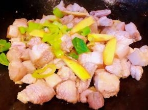 五花肉炒至变色出油放入葱姜炒出香味