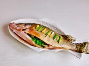 鱼肚子里塞满香菜，葱白，姜丝。