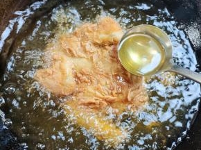 露在外面的用勺子浇油！火力不能过大，过大的话，外面糊掉，里面还没熟透！也不能过低，过低的话，炸的时候容易鼓泡，鸡皮也容易掉落！