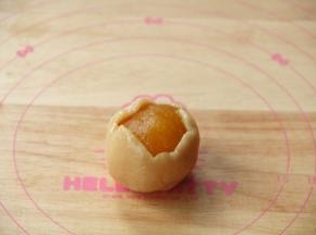 放上馅料球，翻转，馅料球在下，饼皮在上，让饼皮贴合到馅料球上，再翻转。