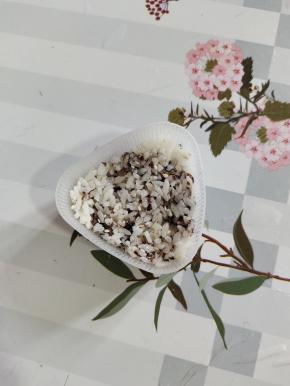 取适量的翻拌好的米饭，放入三角饭团模具里！