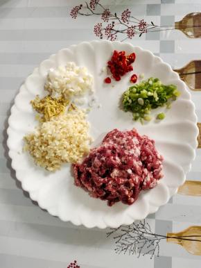 五花肉洗净剁成肉末，蒜瓣剁成蒜末，生姜切成姜末，葱白切成葱末，葱叶切成葱花，小米辣切成小圈儿备用！