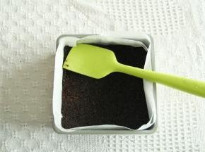 奥利奥饼干碎放入保鲜袋略微擀细，黄油隔热水融化成液态。两者混合拌匀。方盘垫入油纸，拌匀的饼干倒入压平压结实。