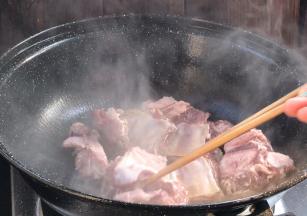 起锅热油，放入排骨