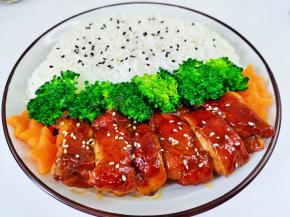 盘子盛一碗米饭，码上胡萝卜与西蓝花摆放在上面，把切好的鸡腿肉摆在米饭上面，淋上料汁即可。