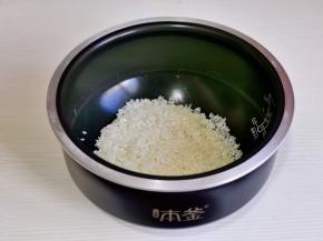 米淘好倒入电饭煲中。