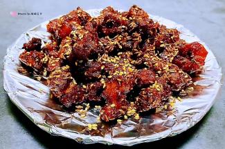 孜然羊肉粒装人盘中最后撒上芝麻就大功告成了