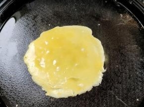 电饼铛提前预热，刷一层薄油！舀一勺蛋液倒进去，勺子底部慢慢的转动，摊成一个小圆饼的形状！