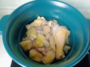 焯好水的三黄鸡放入锅里，加料酒一勺。