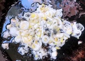 另起锅倒入底油加热放入葱蒜爆香