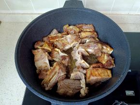 放入牛排骨，快速翻炒上色。