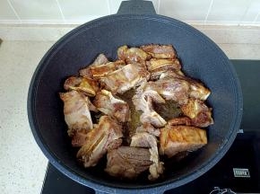 放入牛排骨，快速翻炒上色。