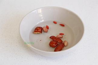 红枣去核、切块。花生、枸杞，也放入碗里，清洗干净，捞出沥干水，不需要浸泡。