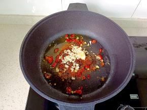 锅里放适量的食用油，加蒜末，辣椒粉，孜然，辣椒段翻炒出香味。