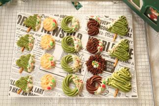 烤完取出冷凉，白巧克力隔热水化成液态。冷凉好的曲奇，一边蘸上适量白巧，撒上榛子仁碎、杏仁脆片或圣诞糖珠，按个人喜好装饰！