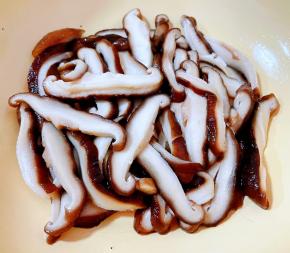 香菇去蒂洗净放入开水中焯水断生后立即放入冷水中过凉再沥干水分切成薄片状