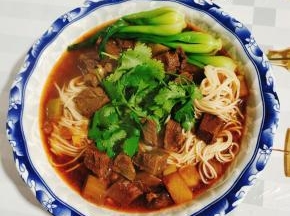 碗中捞两筷子面条，放入适量的面汤，再浇上一大勺红烧牛肉面的卤，最后放上小青菜和葱花，一大碗份量超满足的红烧牛肉面就做好了！开吃吧！