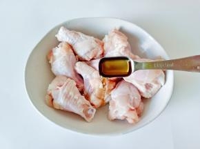 浸泡好的鸡腿控干水分，用牙签多扎一下，便于腌制时入味，加入料酒两勺。