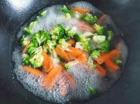 锅中烧开水，加一点点油盐，放入西兰花胡萝卜焯水一分钟捞出。