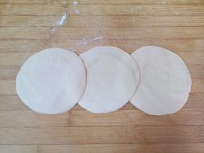 压扁擀成中间稍厚边缘薄的包子皮。 