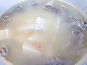 加入豆腐继续炖煮入味，可按自家口味加入白胡椒粉