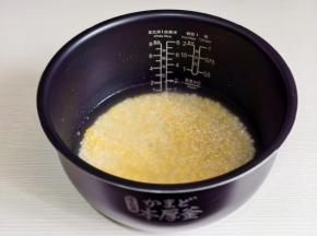 大米与小米混合淘洗，倒入电饭煲内胆中，按内胆的刻度指示加水。