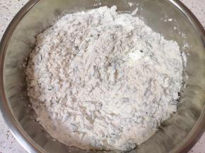 将碎苜蓿菜放入盆里，加入中筋面粉搅拌均匀。