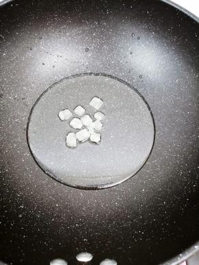 锅里加入适量油烧到七成热时，把冰糖放入锅中炒出糖色