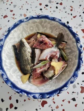 鱼头和鱼骨剁成小块，放入适量的料酒，生抽，姜片，葱段和少许盐抓拌均匀腌制10分钟左右备用！