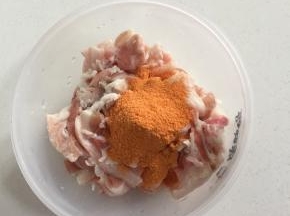 把切好的五花肉片放入碗中，倒入适量的新奥尔良烤肉料！