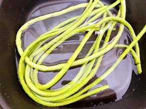锅里烧水，水开后放入豆角焯至断生