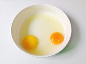 碗里打入两个鸡蛋。