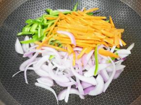 锅里继续倒油烧热，下入蔬菜丝。