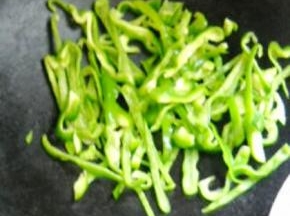 青椒放入锅中煸软。