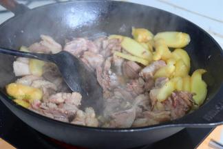 锅烧热，放少许油，煸炒香大蒜、仔姜，倒入鹅肉，旺火爆炒至表面油，炒干。